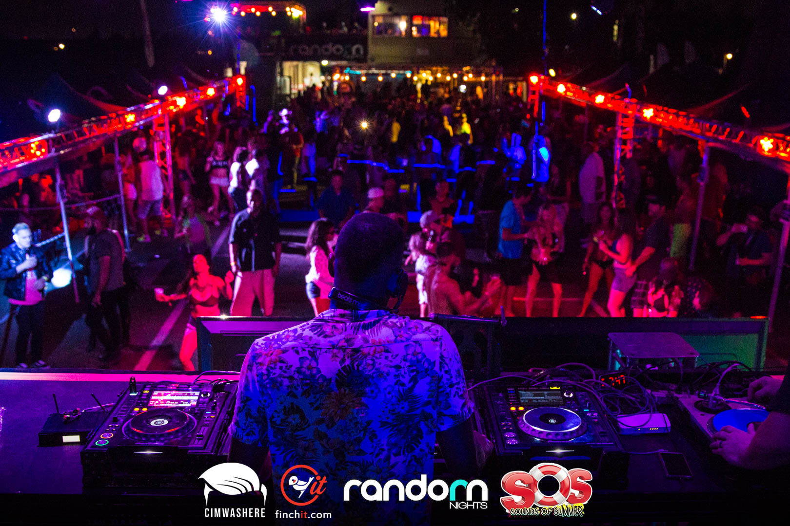 Crowd seen from behind the DJ booth