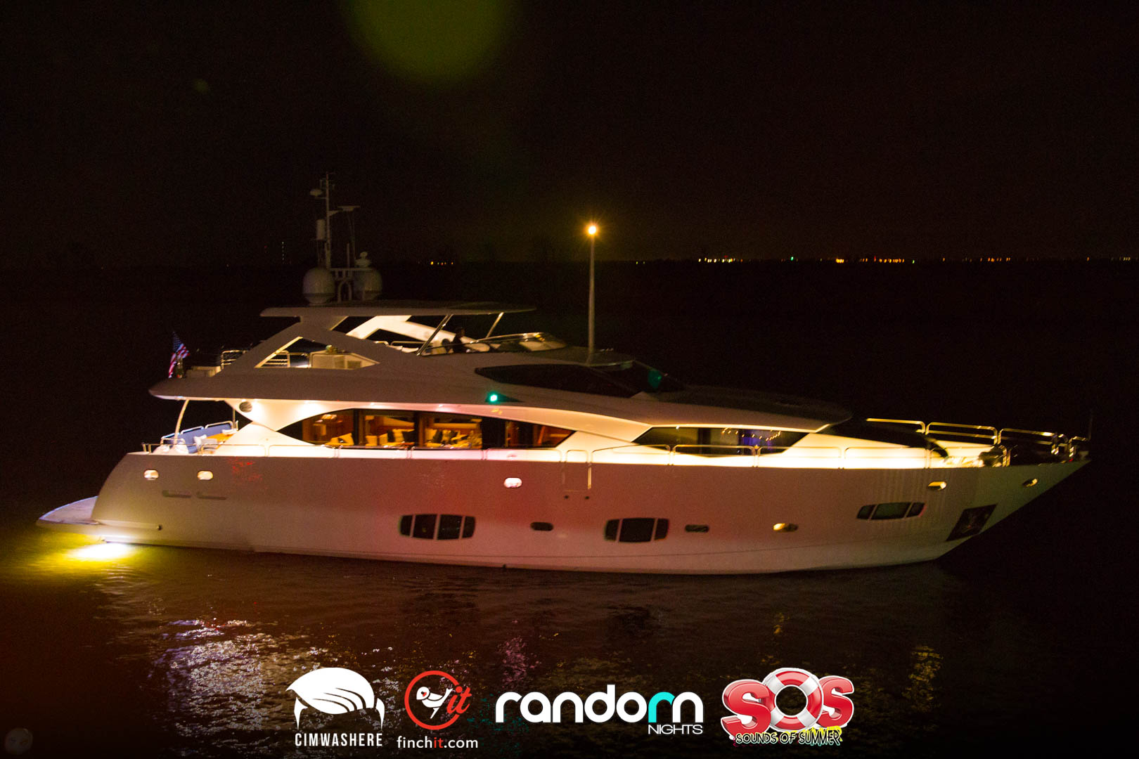 Yacht lit at night on dark water