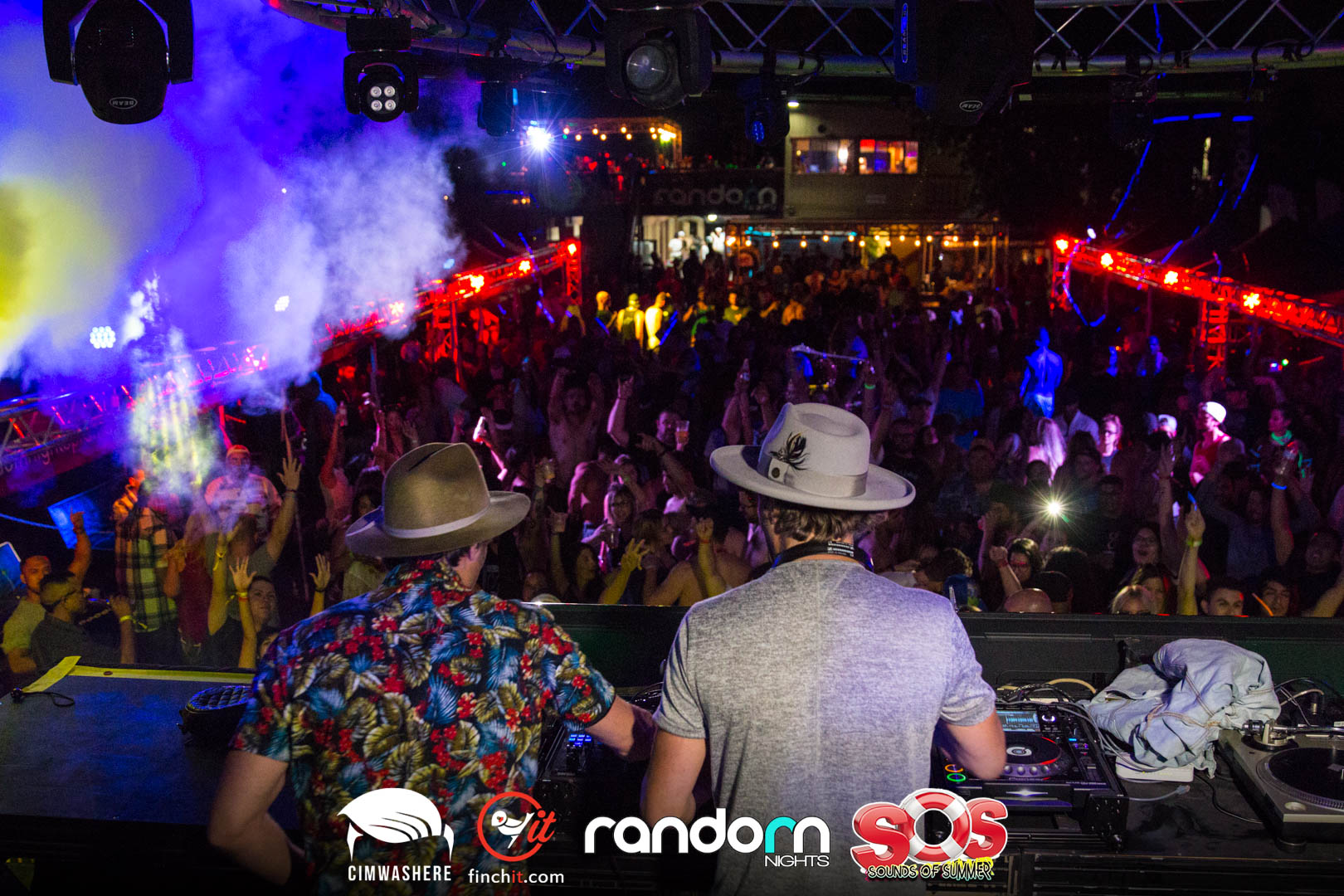 Performer facing a smoke-filled crowd