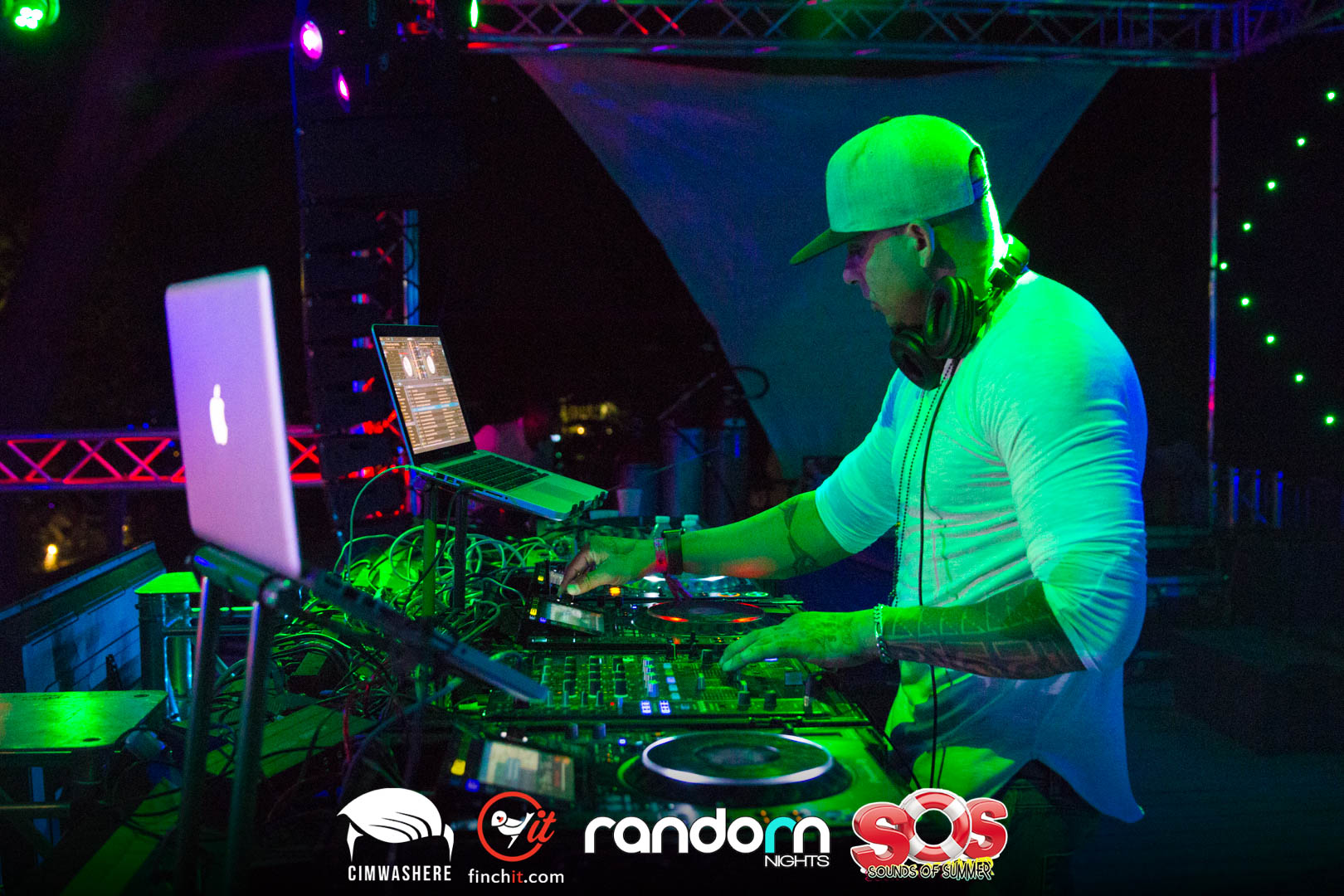 DJ in green light at the mixer