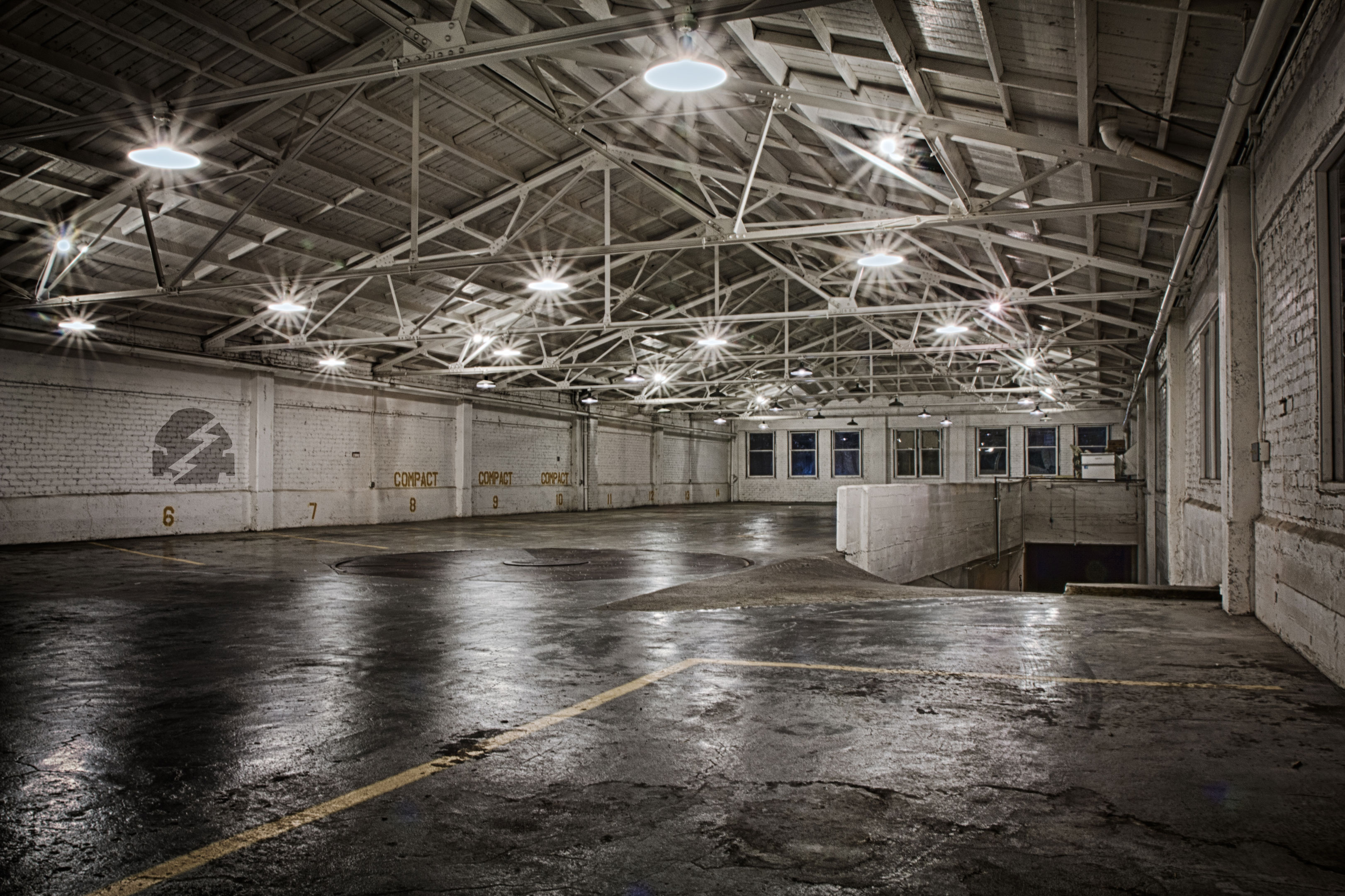 Empty warehouse floor with overhead lights
